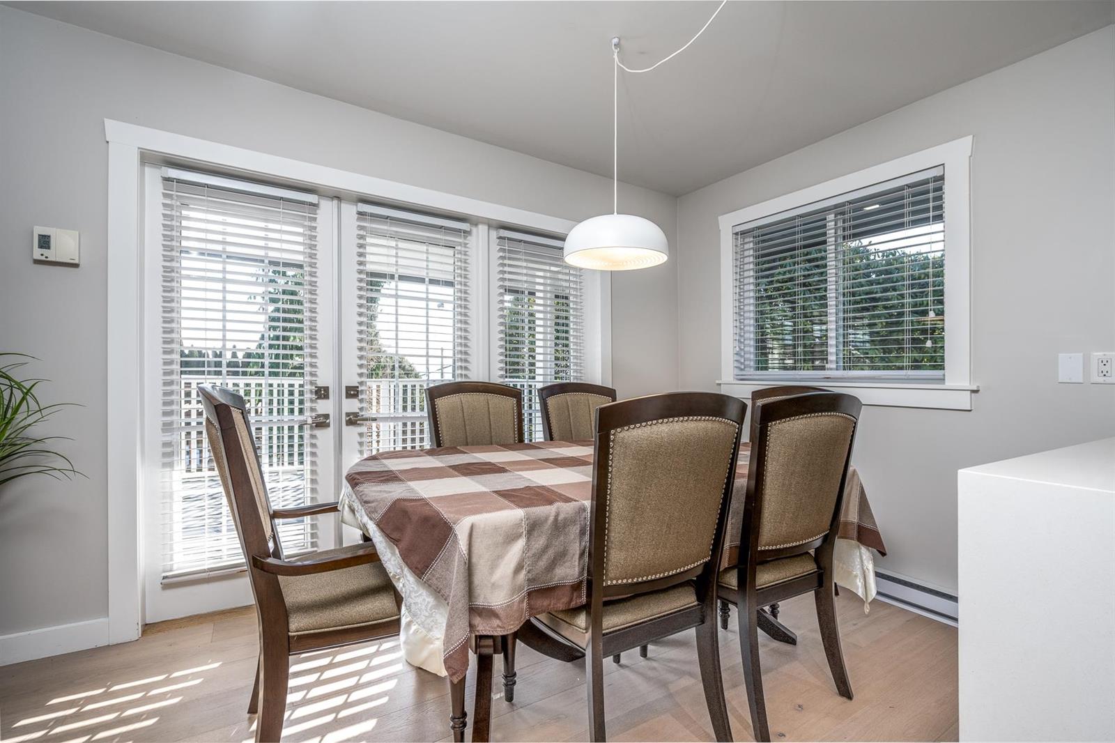 The dining room, a bay of windows behind the table.