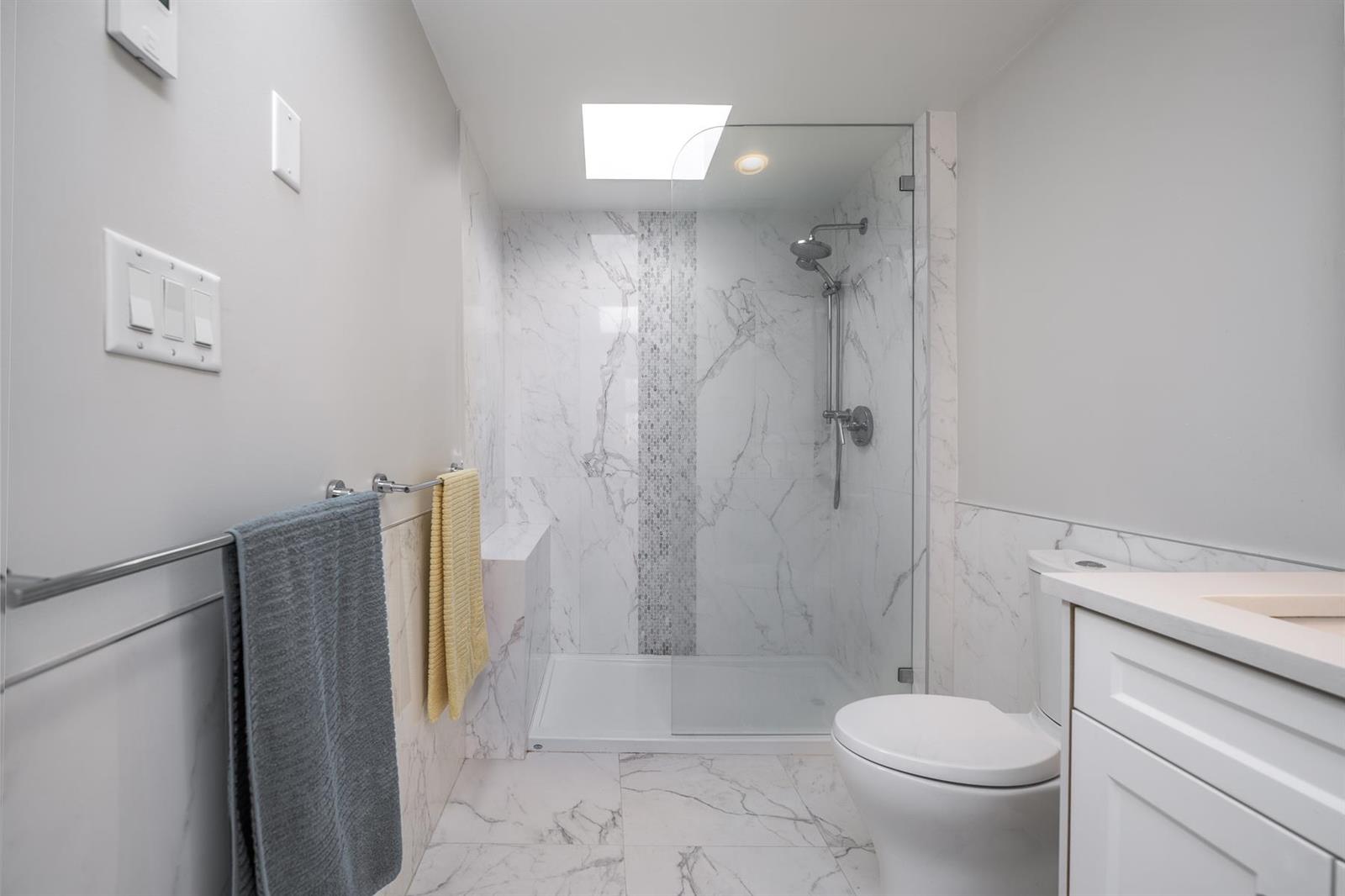 The shower, marble carried to the ceiling.