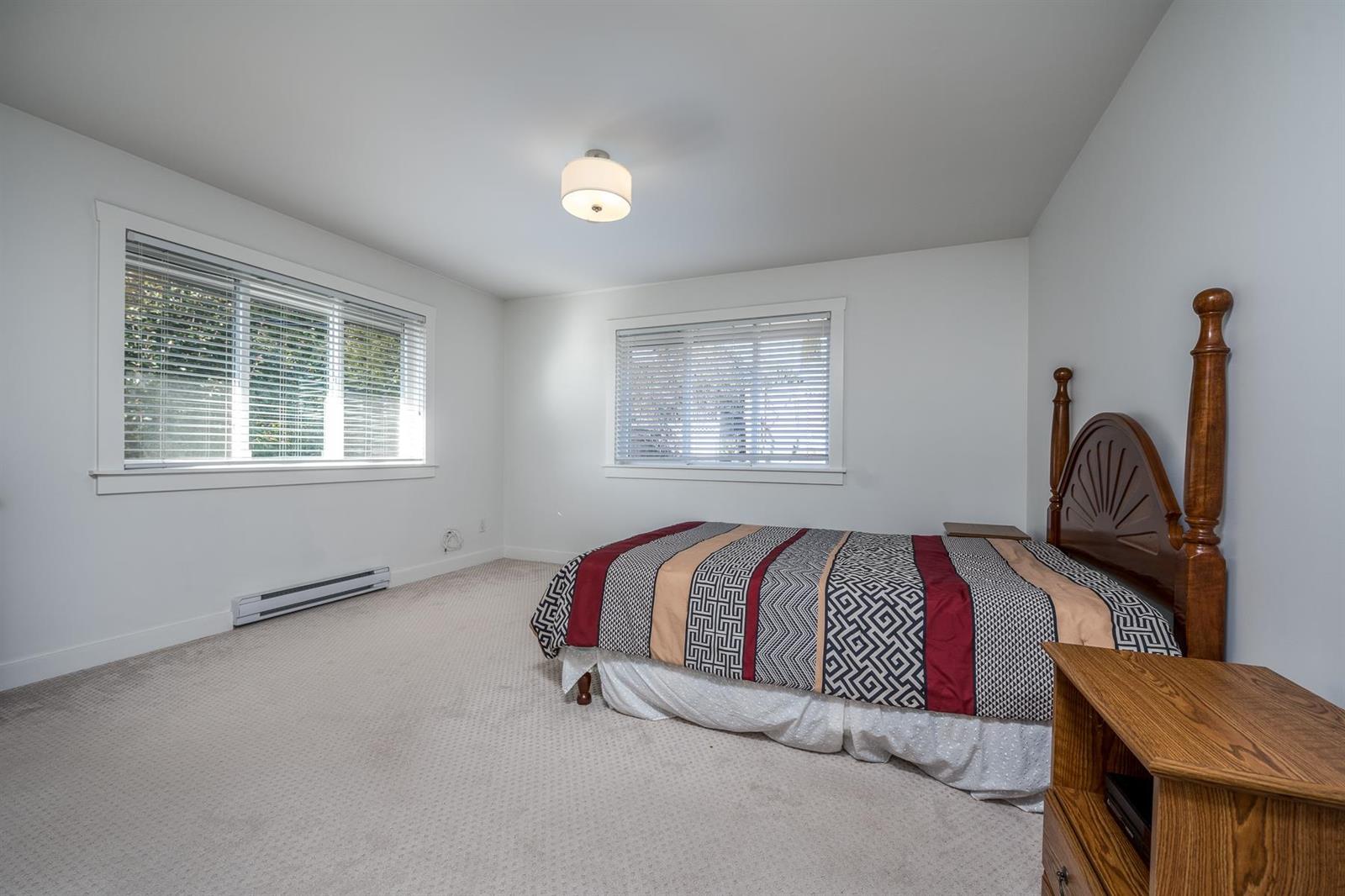 A third bedroom, windows on two walls.
