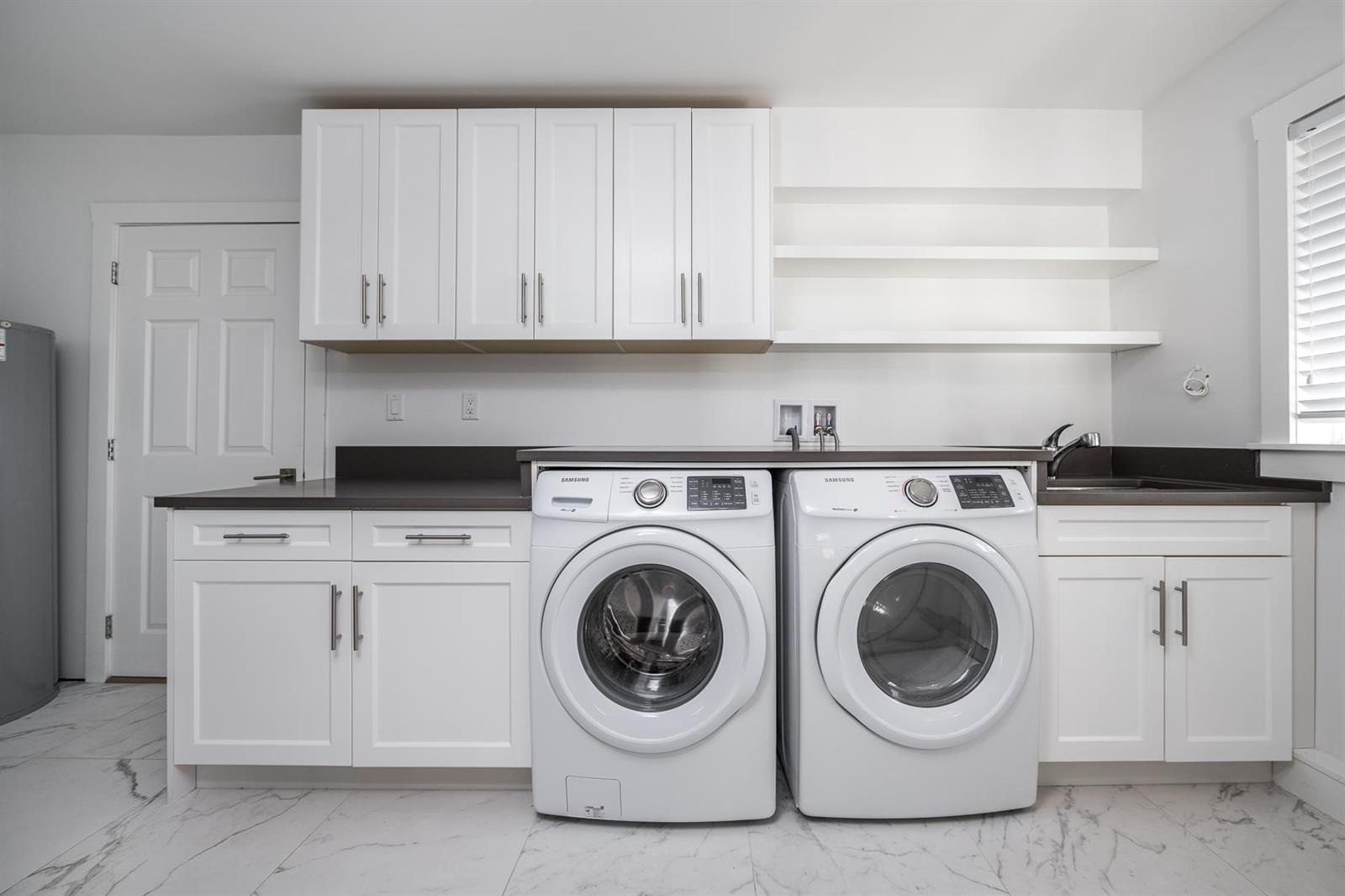 The laundry, machines side by side under the cabinets.