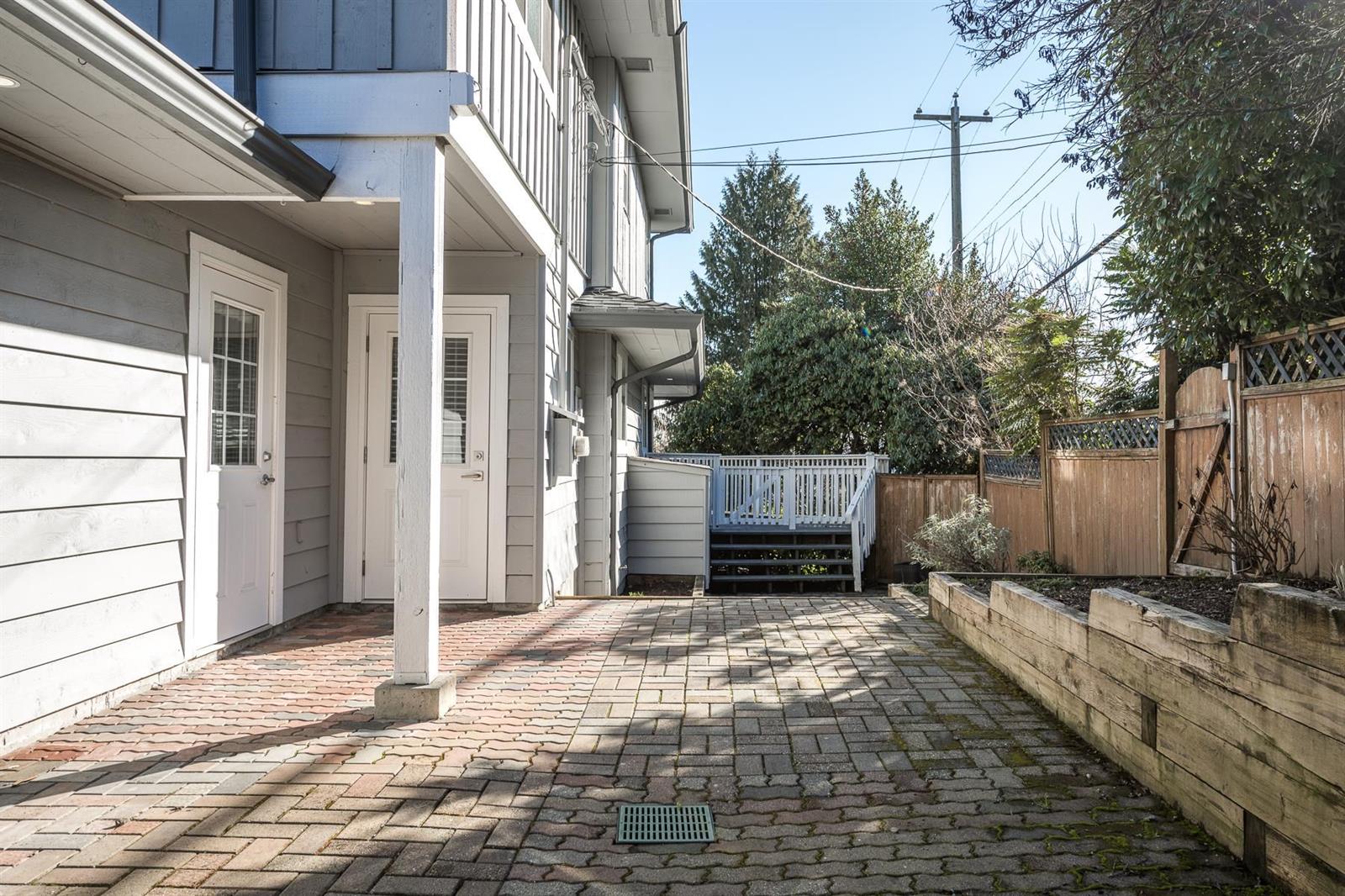 The paved passage along the side of the house.