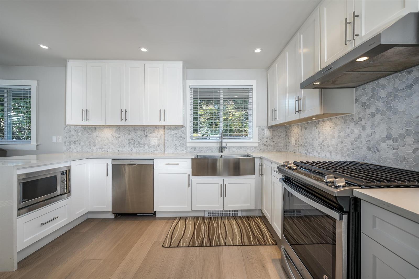 The kitchen from the far end, windows over the run of counter.