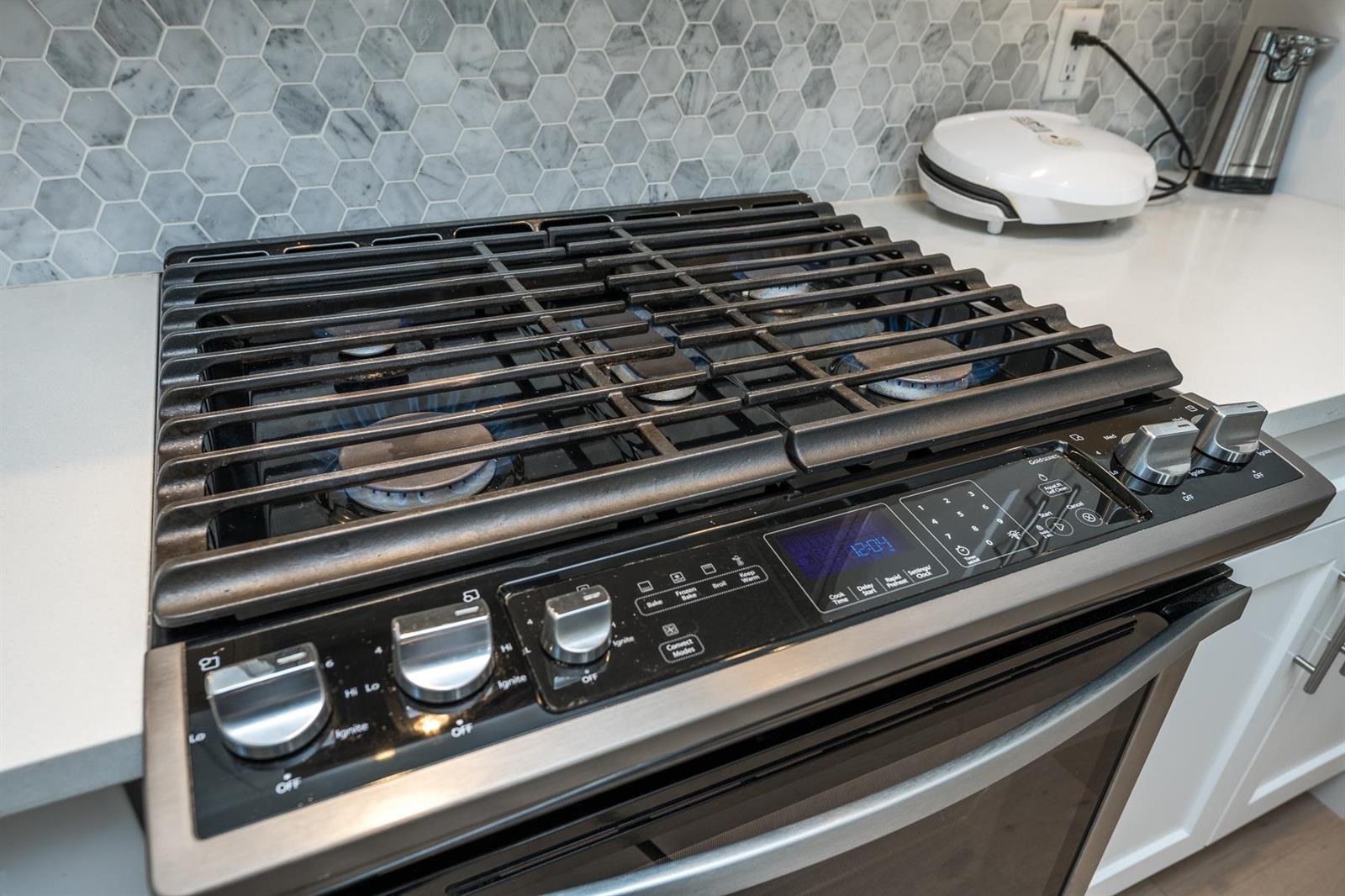 The gas cooktop set into the counter.