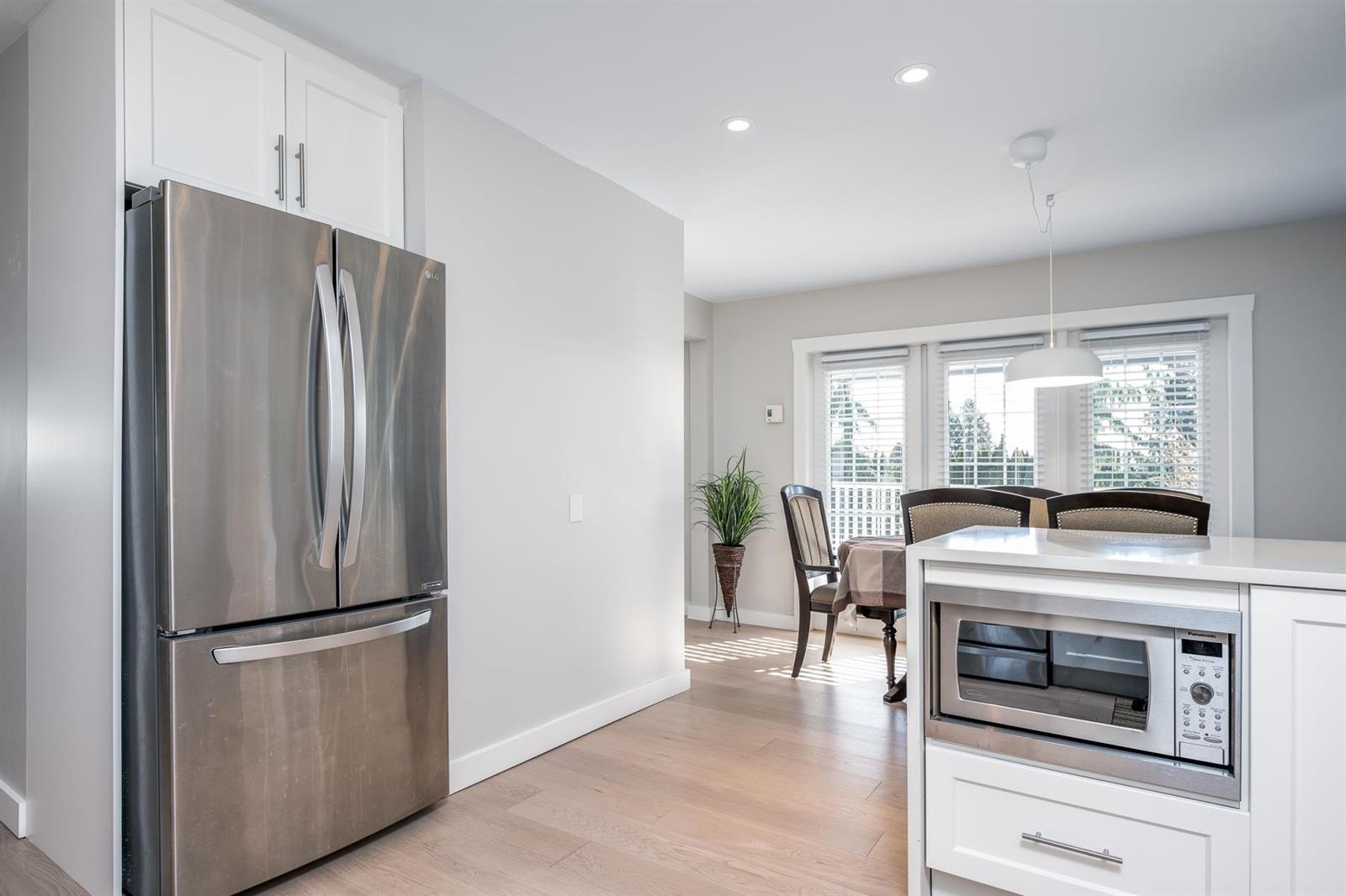 The tall cabinets at the end of the kitchen, the dining room through the opening.