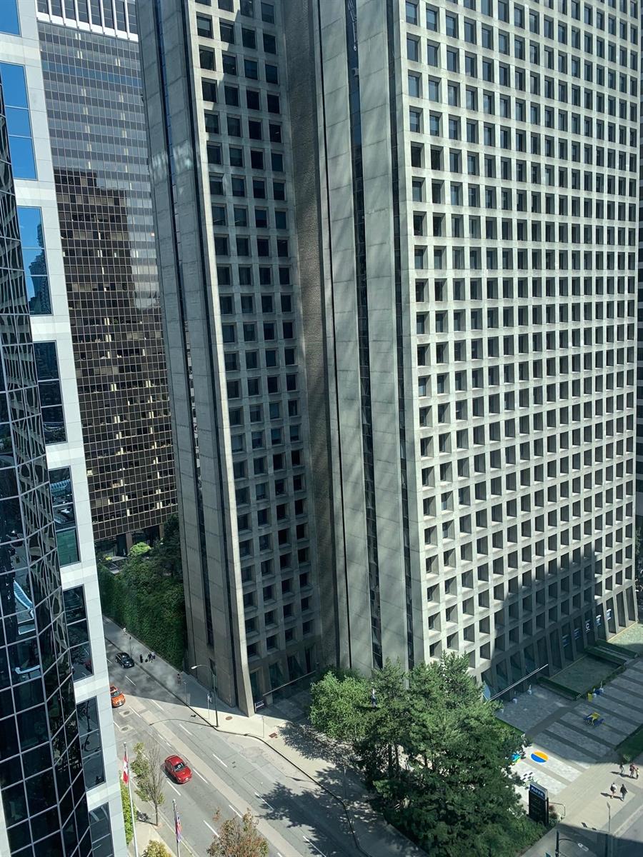 The view straight down Alberni Street, towers either side and the trees below.