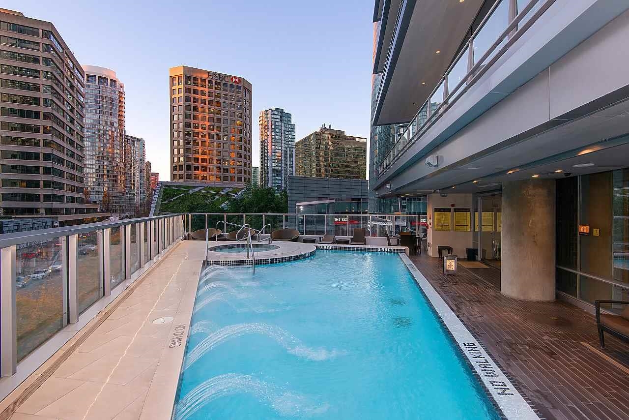 The outdoor pool on the terrace, loungers along one side and the towers behind.