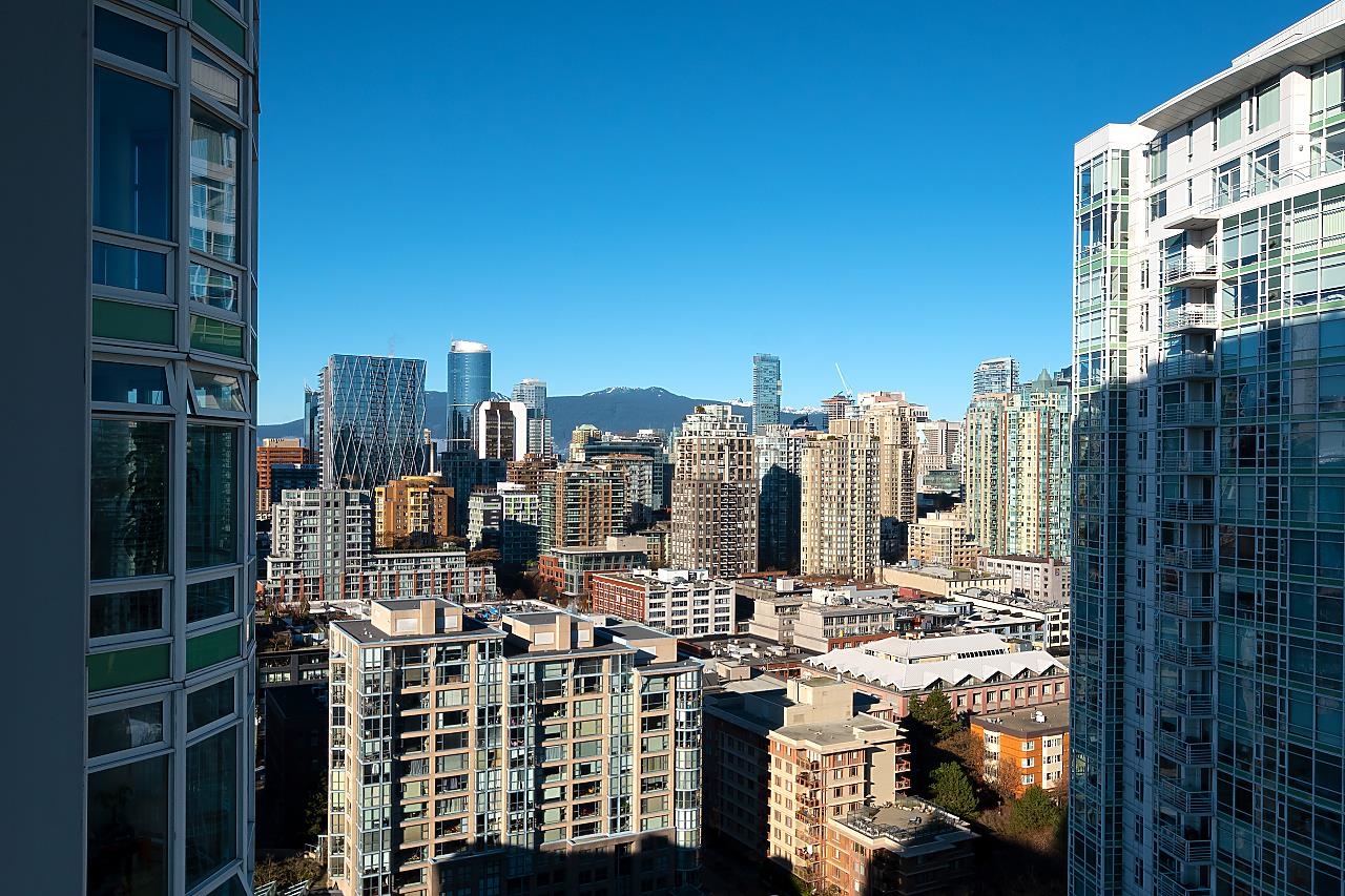 The view north from the window — the downtown towers with the North Shore mountains behind them.