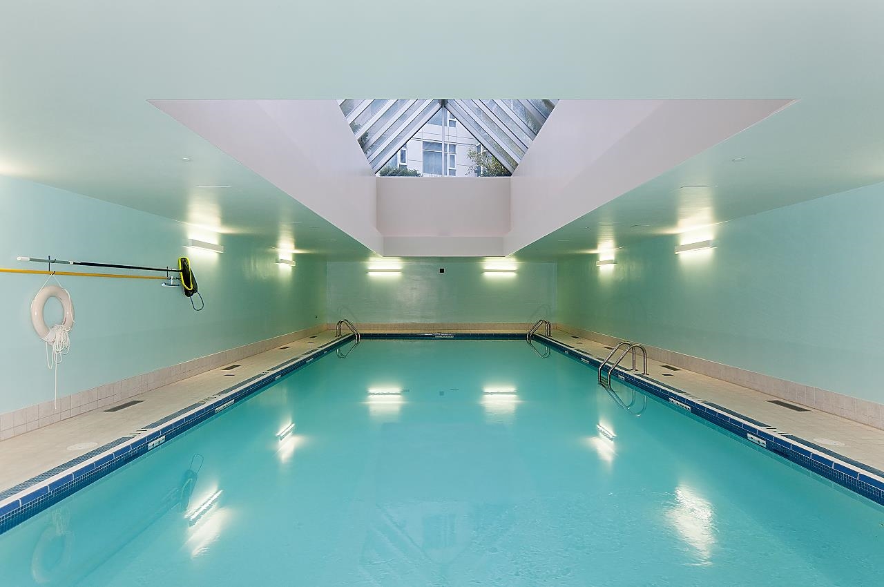 The indoor pool, lit under a pyramid skylight.