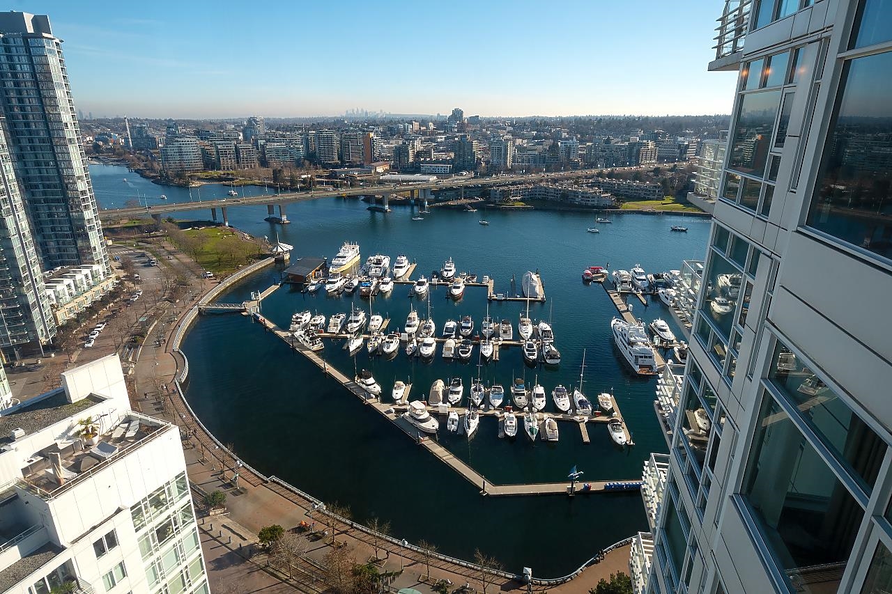 The view from the window — the marina full of boats directly below, the seawall around it and False Creek running out past the bridge.