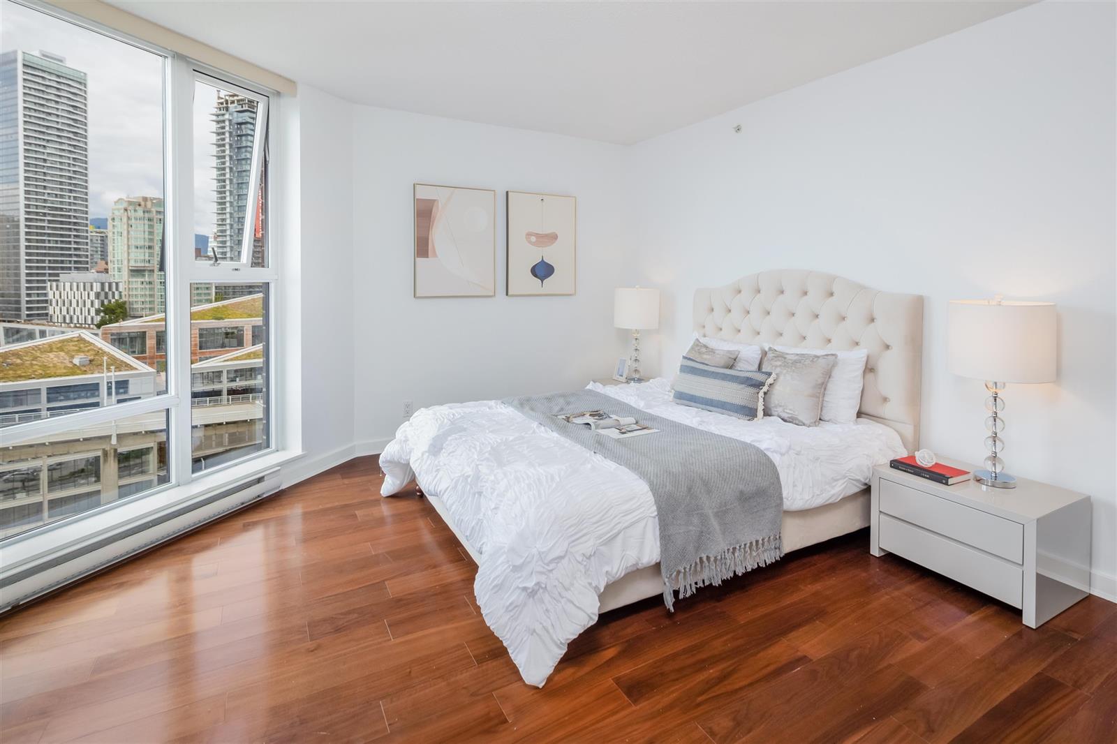 The same bedroom from the doorway, bedside tables either side and the towers outside.