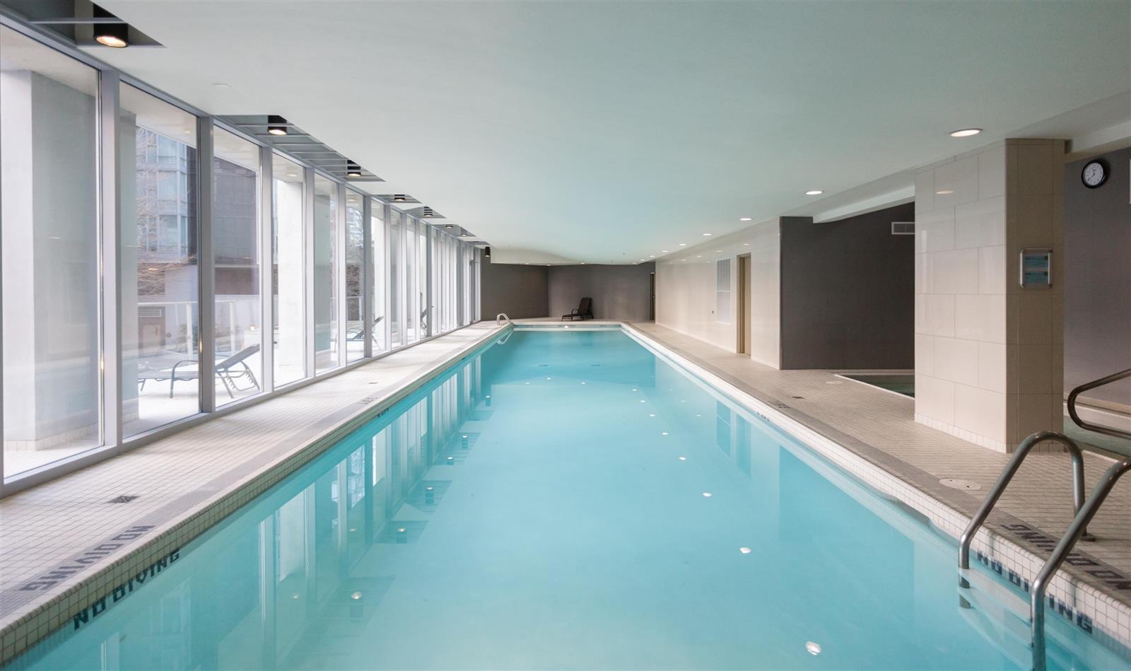 The pool from the far end, tile underfoot and the light coming in along one side.