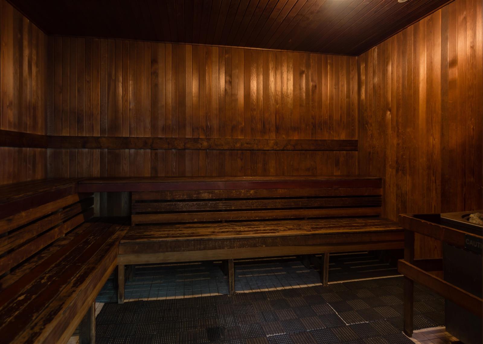 The steam room, timber benches stepped along the walls.