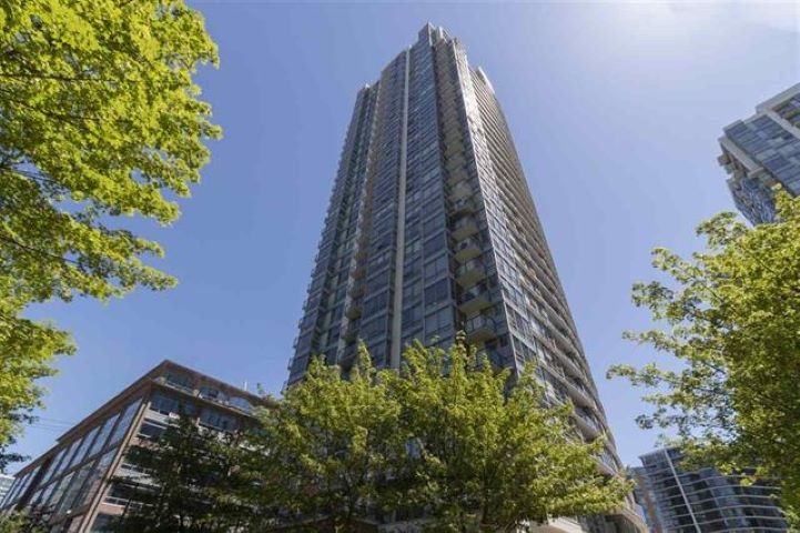 The Max seen from Beatty Street, the tower rising above the trees with its neighbours beside it.