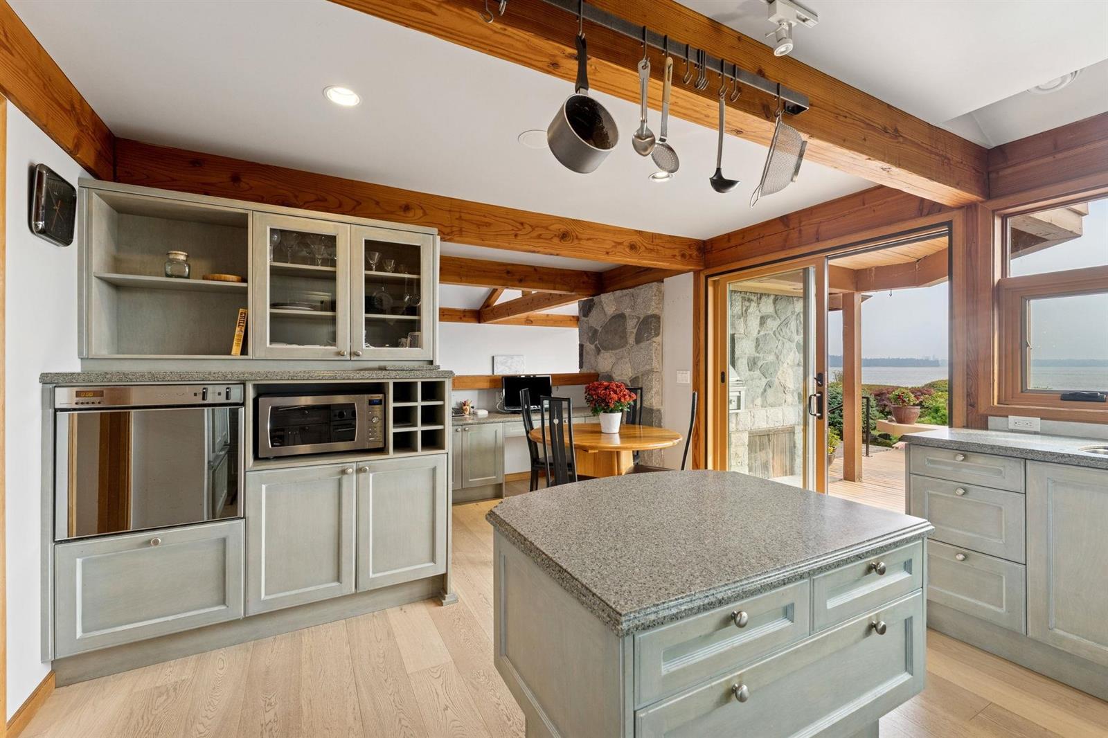 The kitchen from the corner, the island and the cabinetry running the full wall.