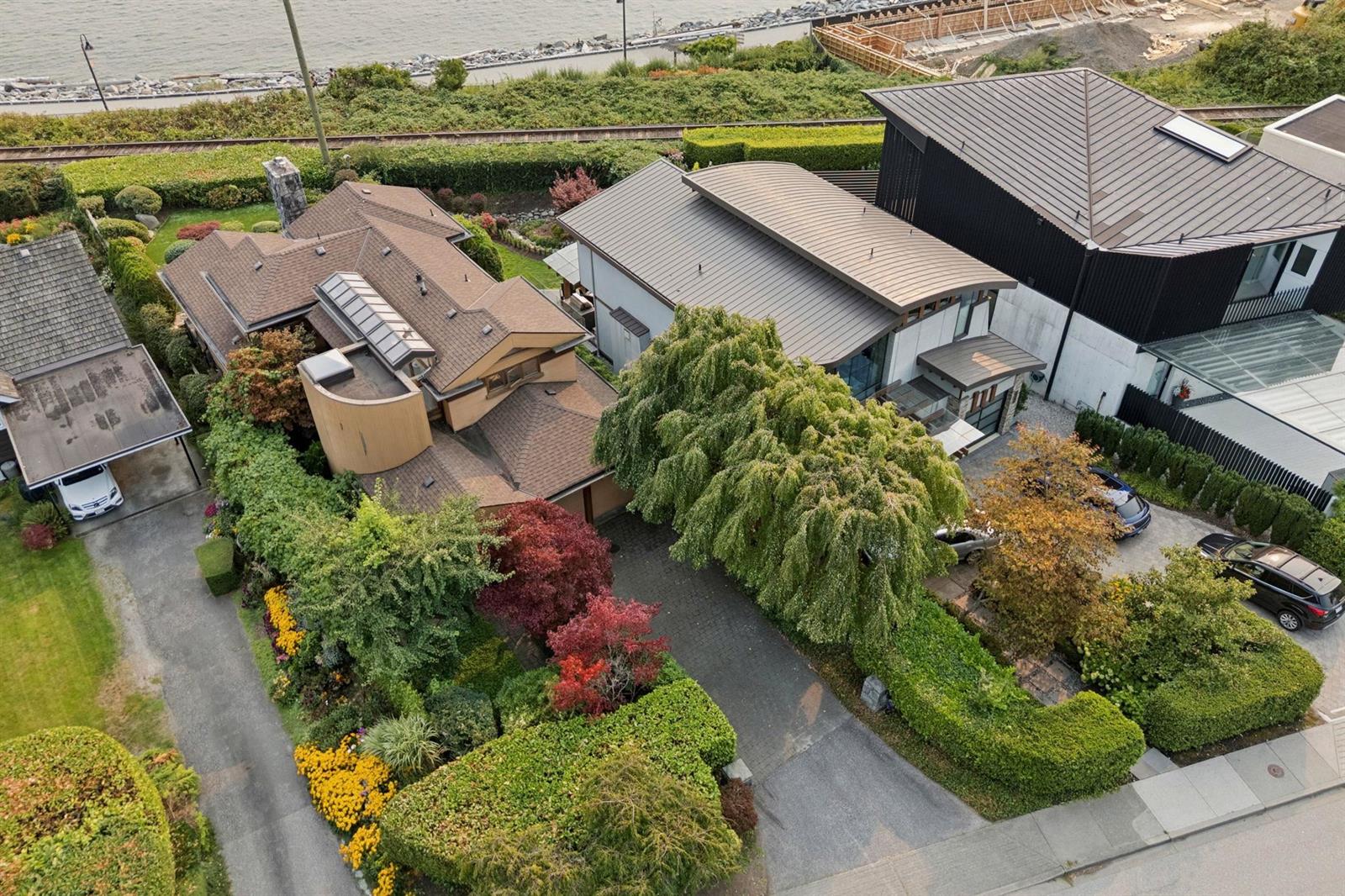 An aerial view of the property from above the shore, the garden falling away to the water.