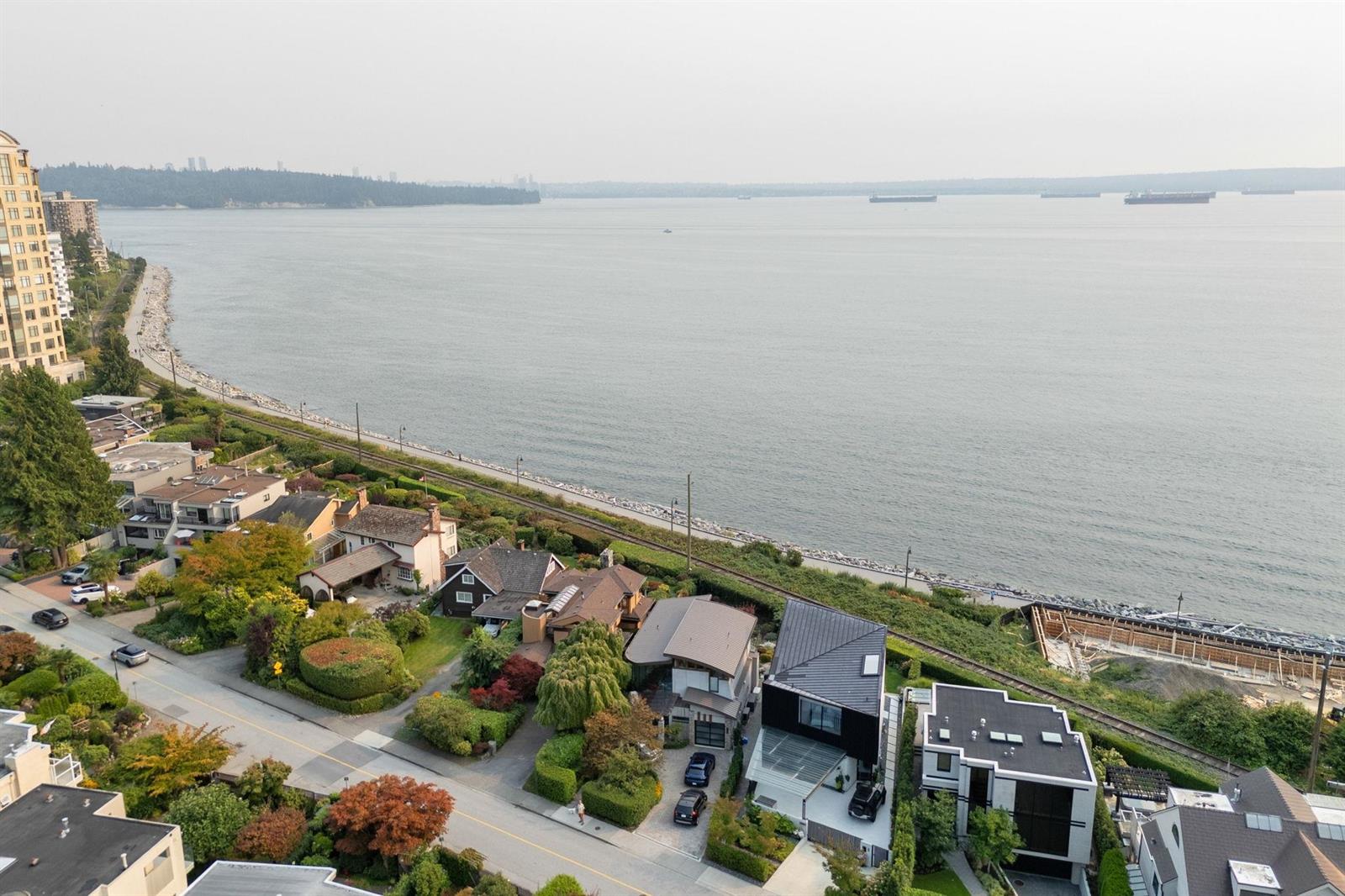 An aerial view along the Dundarave shoreline, the houses stepping down to the beach.