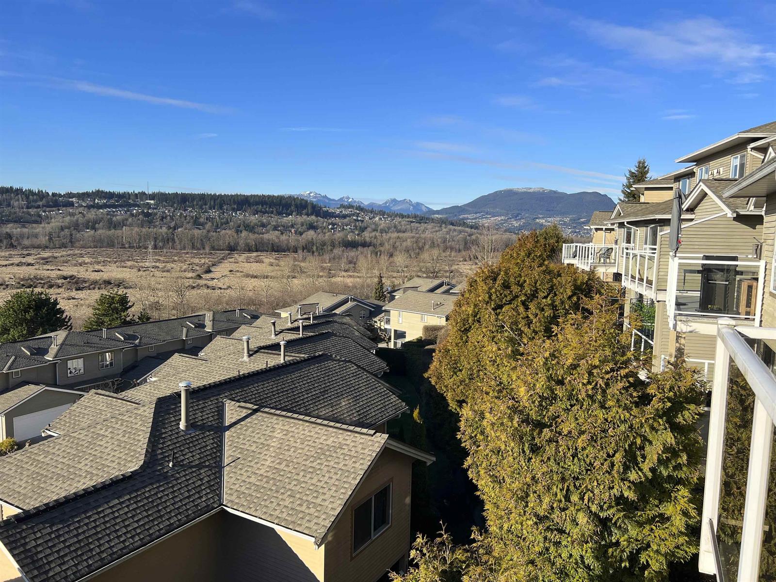 The view from the deck, out over the rooftops of the complex to the flats and the mountains beyond.