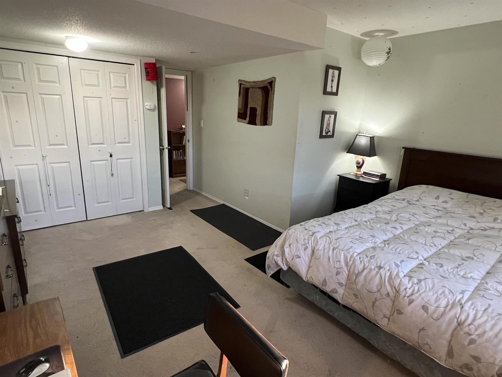 A lower bedroom, with closets along one wall.