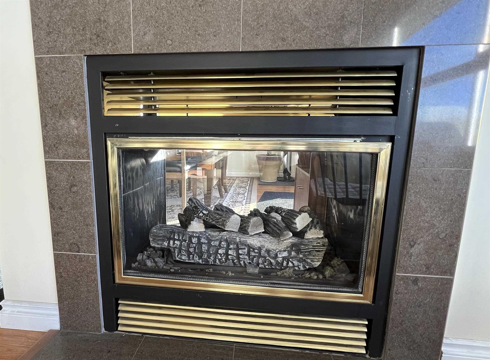 One of the two gas fireplaces, set into a tiled surround.