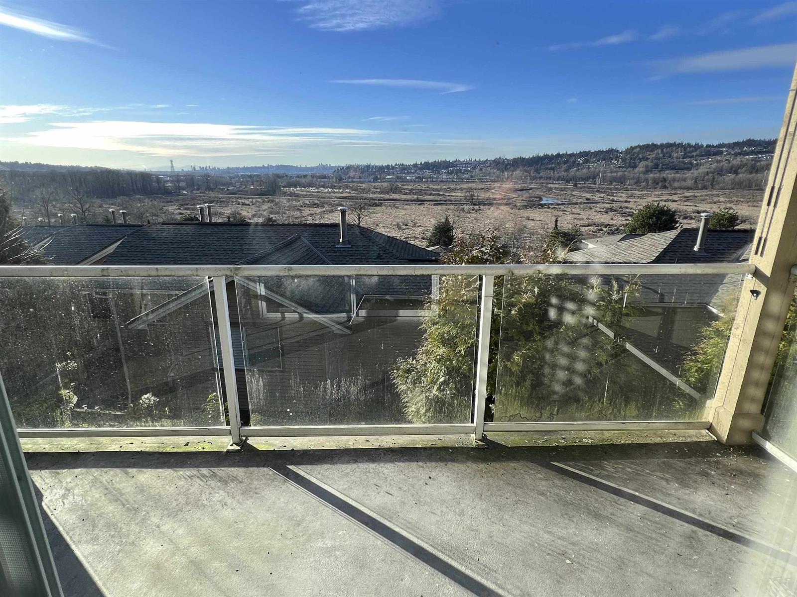 The sun deck, glass panelled along its rail, looking out over the rooftops.