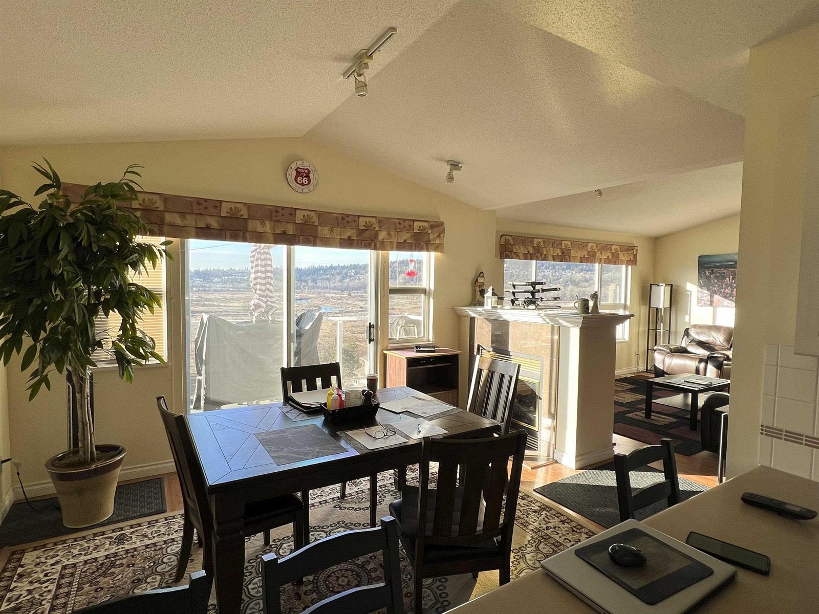 The dining area beside the window, with the kitchen counter beyond it.
