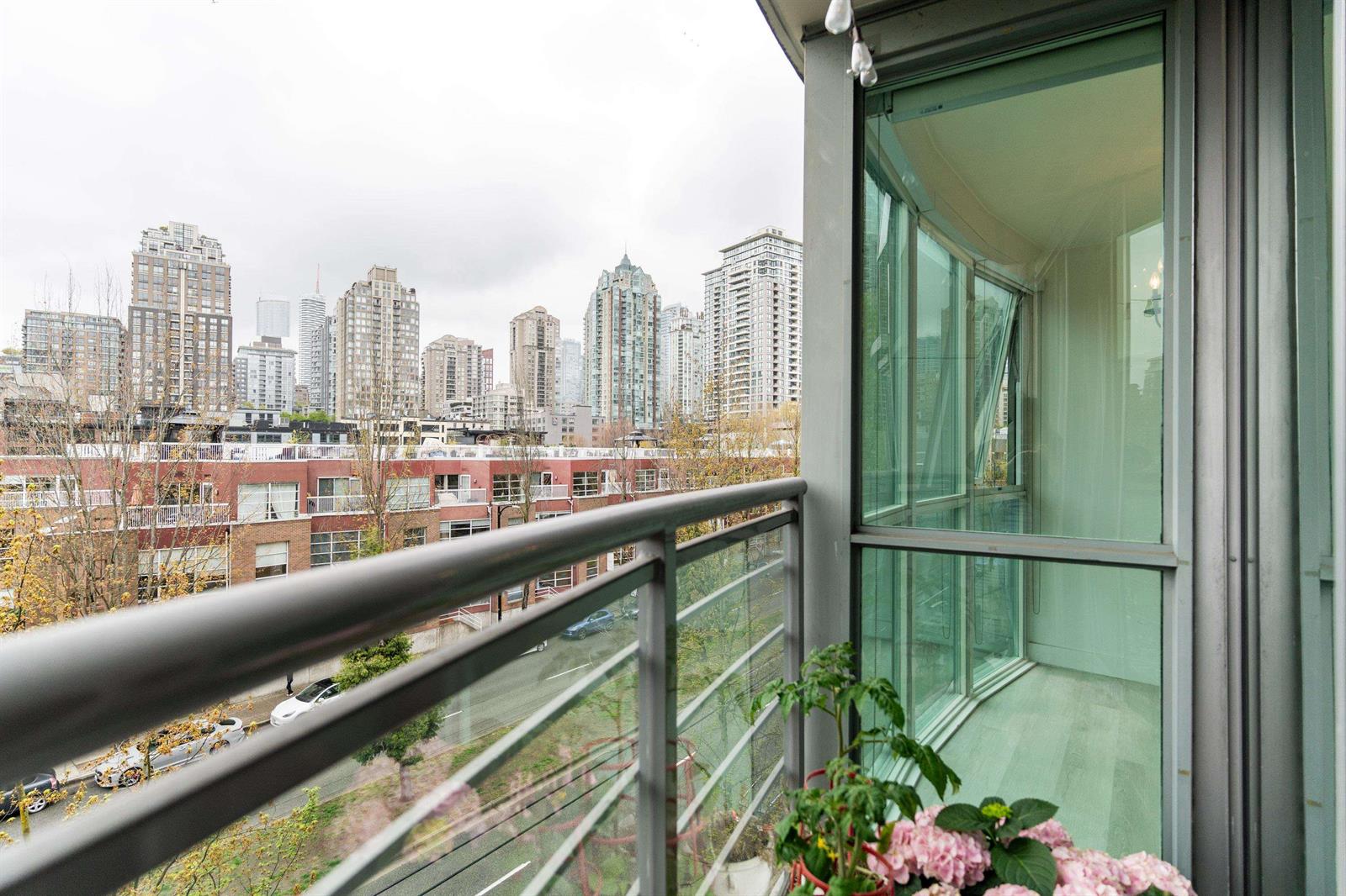 The balcony, glass rail and planting, with the Yaletown towers beyond.