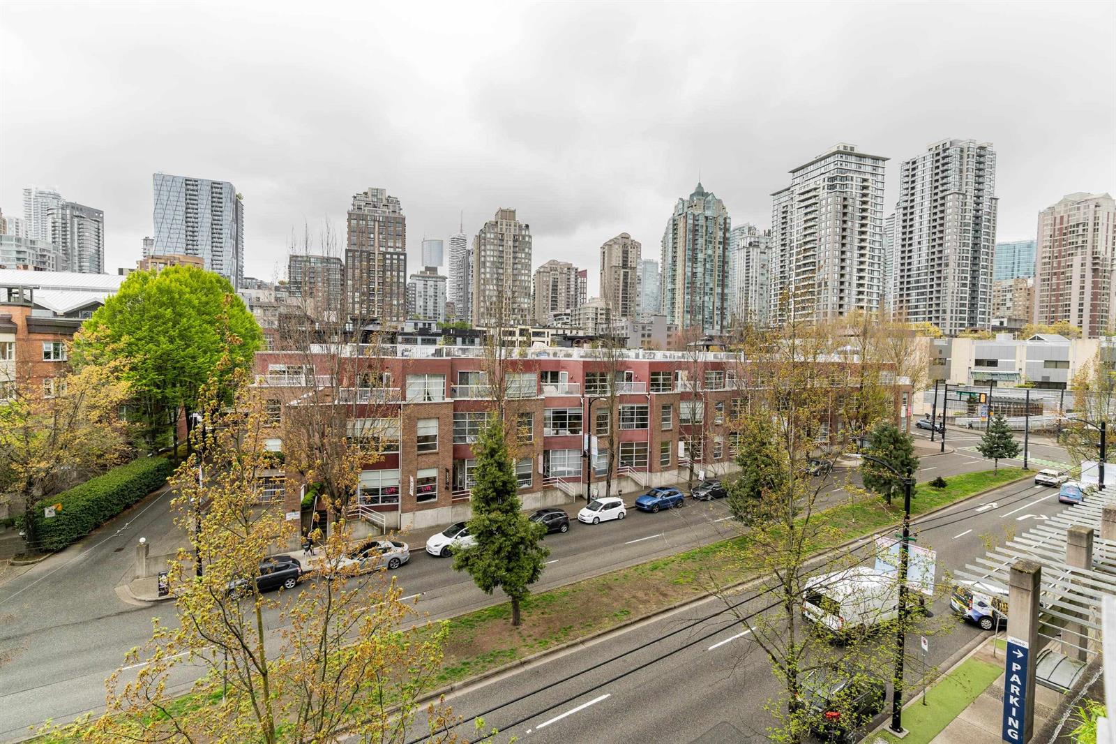 Out over the rooftops opposite to the towers of Yaletown and downtown behind.