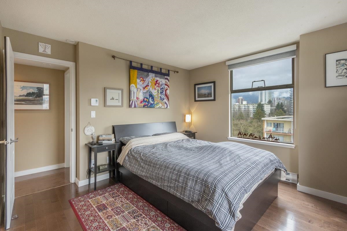 The principal bedroom, the bed against the inside wall and a window to the neighbourhood.