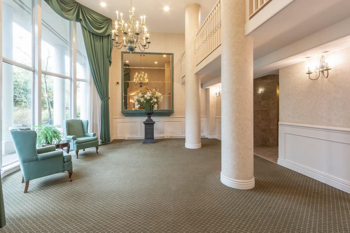 The lobby, columns and seating under a tall ceiling.