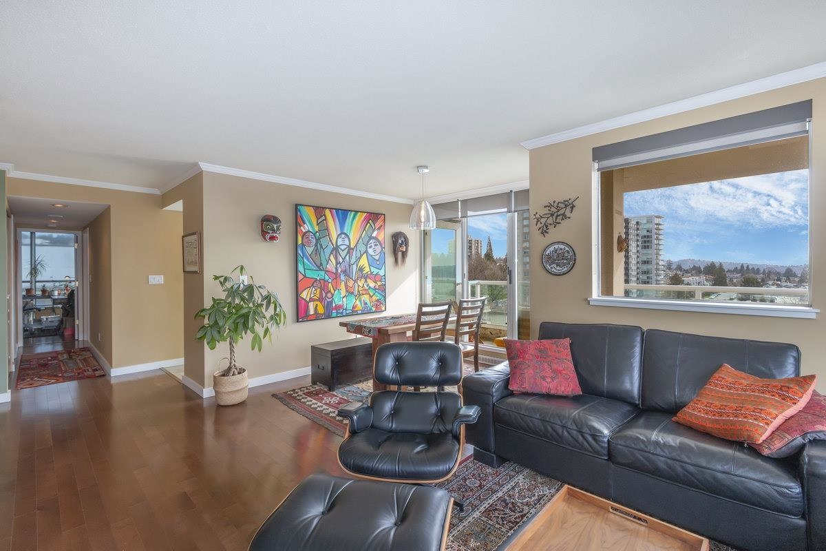 Looking through the living room to the dining end, the rooms opening into one another along the windows.