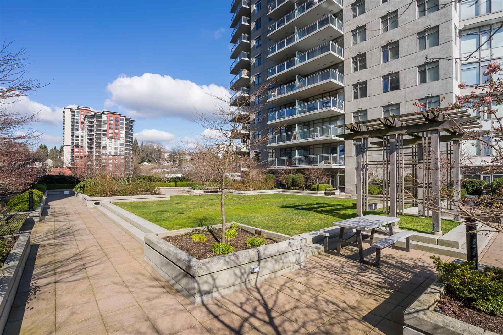 The garden path, planting on both sides and the buildings rising behind.