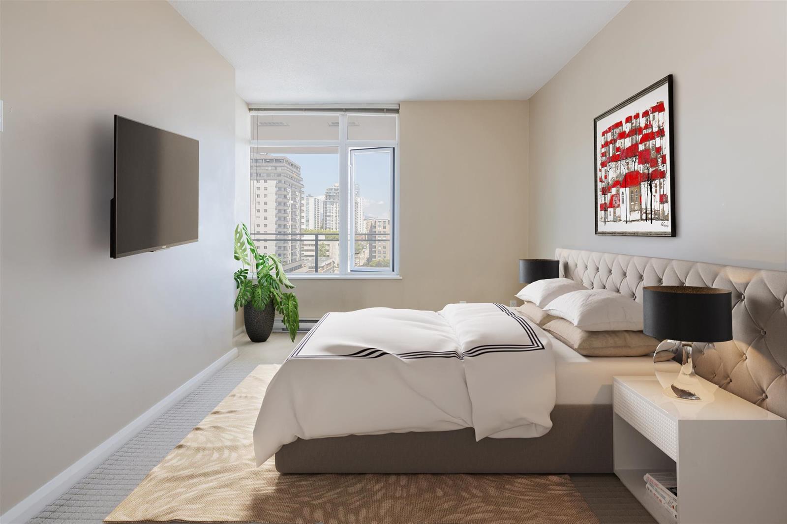 The primary bedroom staged, a bed against the wall with the window and the city light beside it.