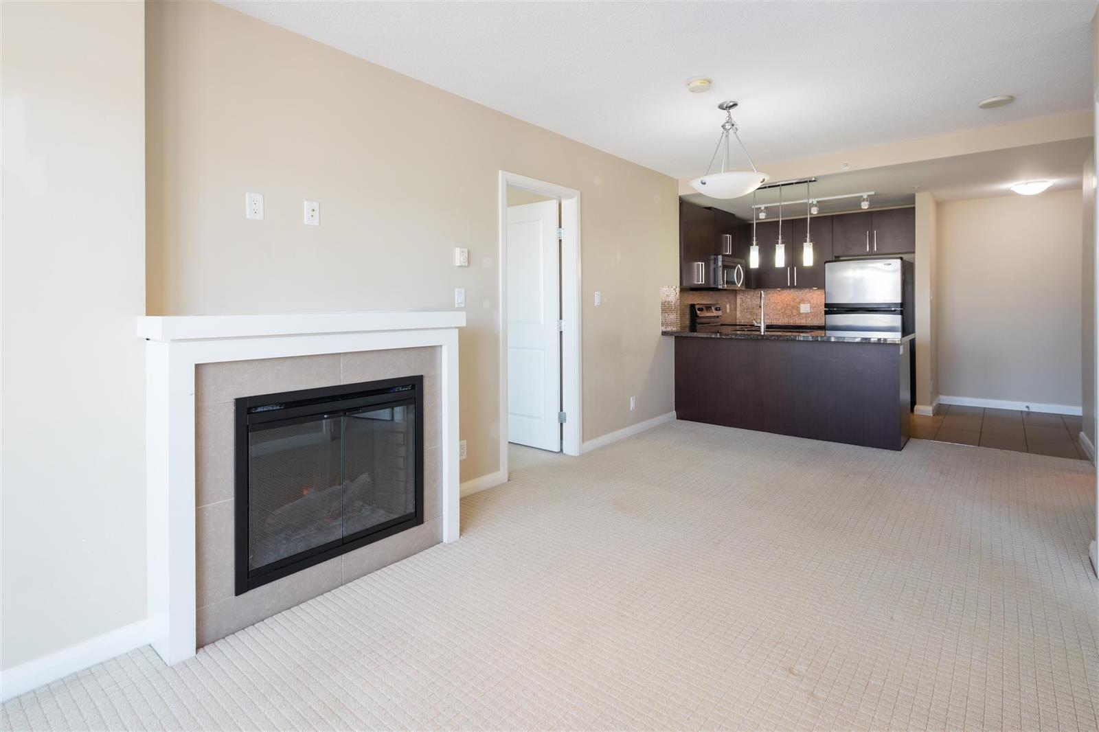 The fireplace set into the living room wall, with the kitchen counter beyond.