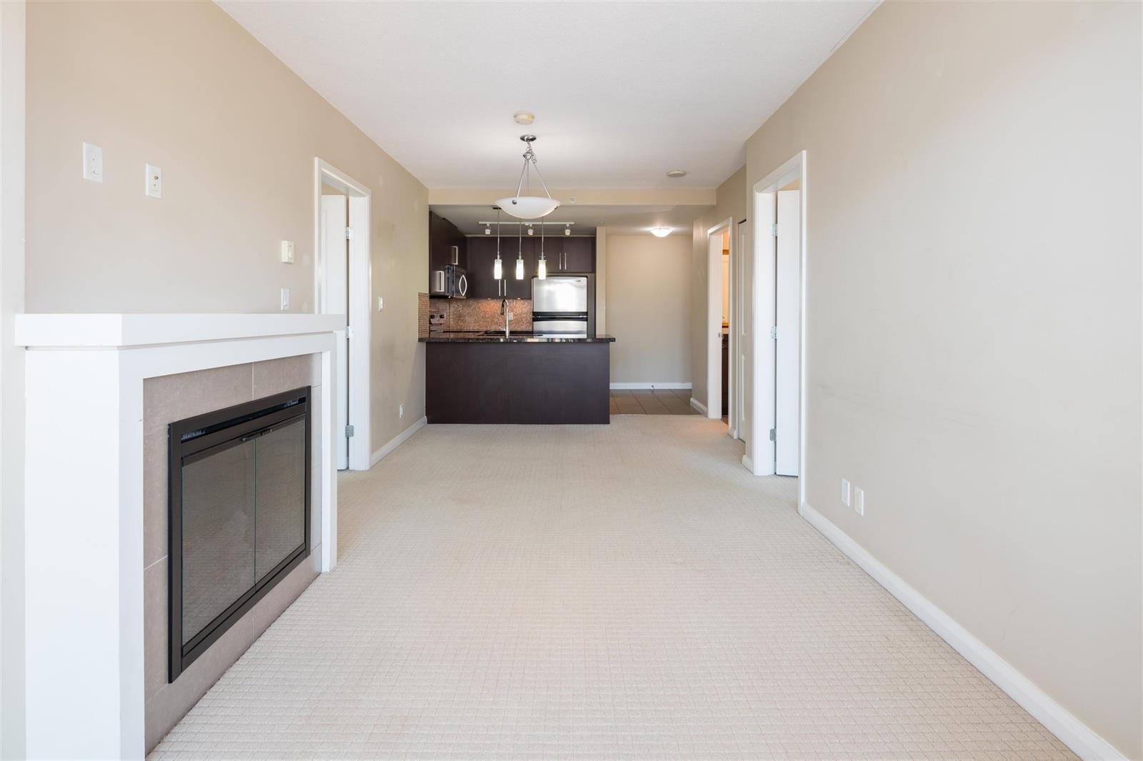 The same wall from further back, the whole run from fireplace to kitchen with the windows on the left.
