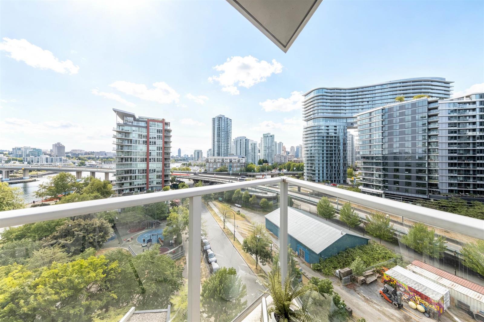 The balcony view, over the park and the street to the towers and open sky.