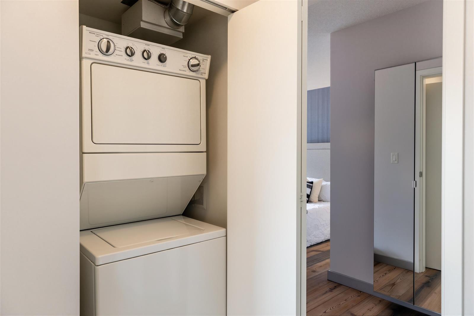 The laundry, a stacked washer and dryer in a closet off the hall.