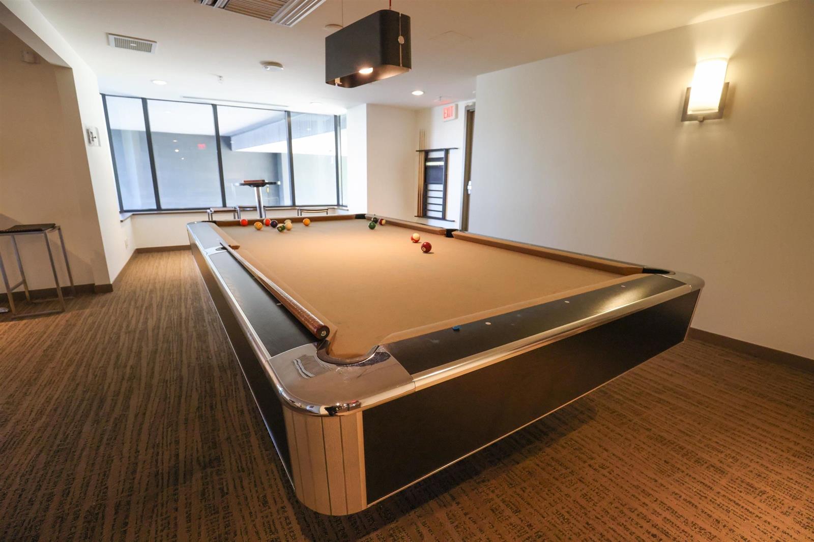 The billiards room, a full size table under the lights.