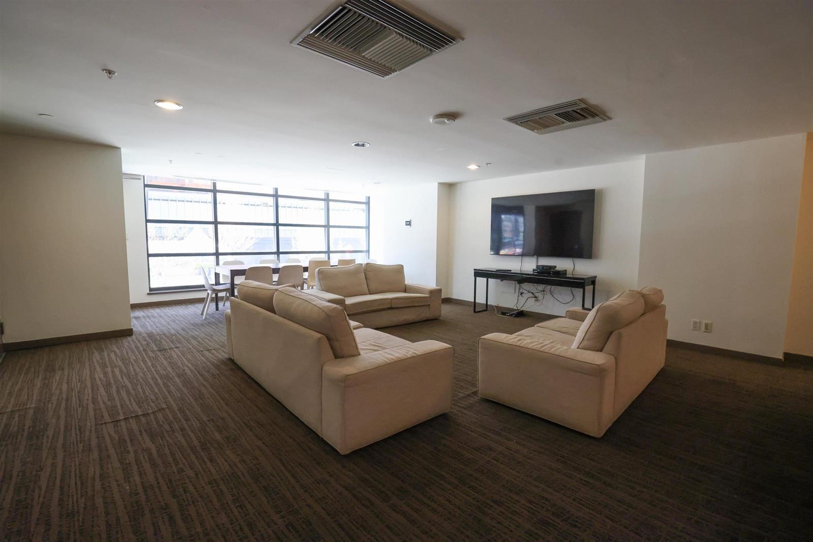 The residents' lounge, sofas around a television.