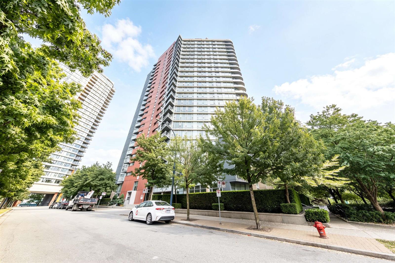 The tower from the street, rising above the trees on Cooperage Way.