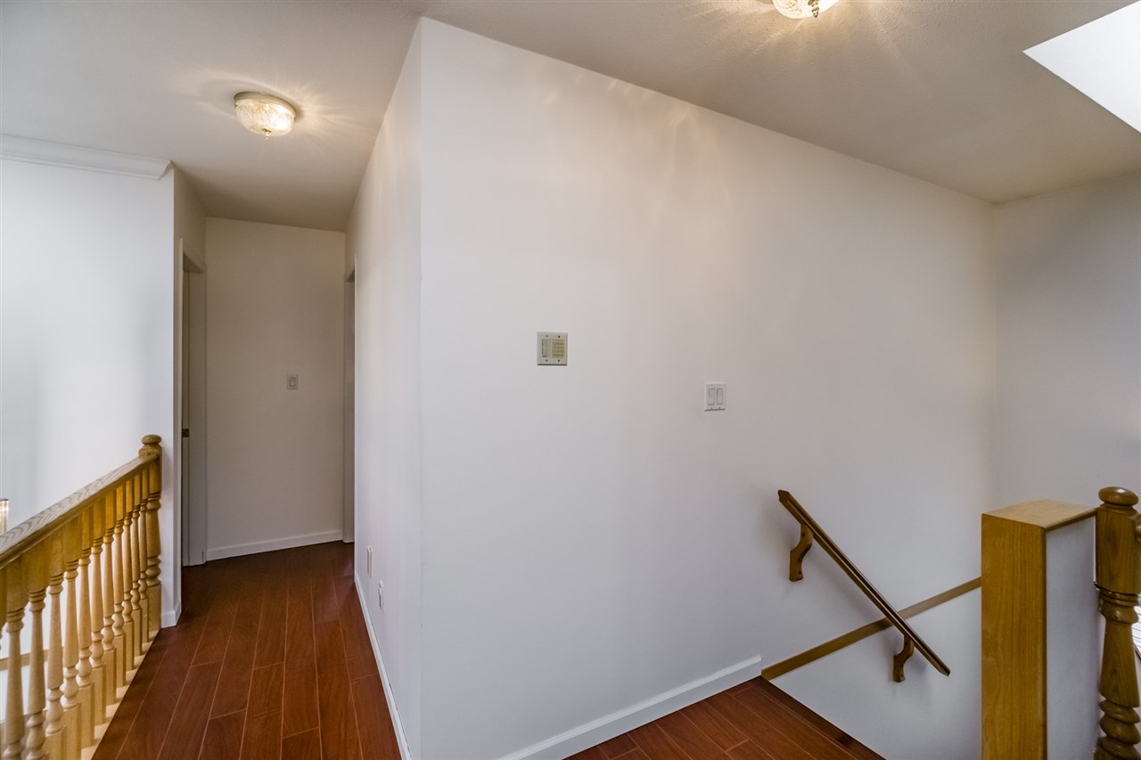 The upstairs landing, the rail at the top of the stair with the hall opening off it.