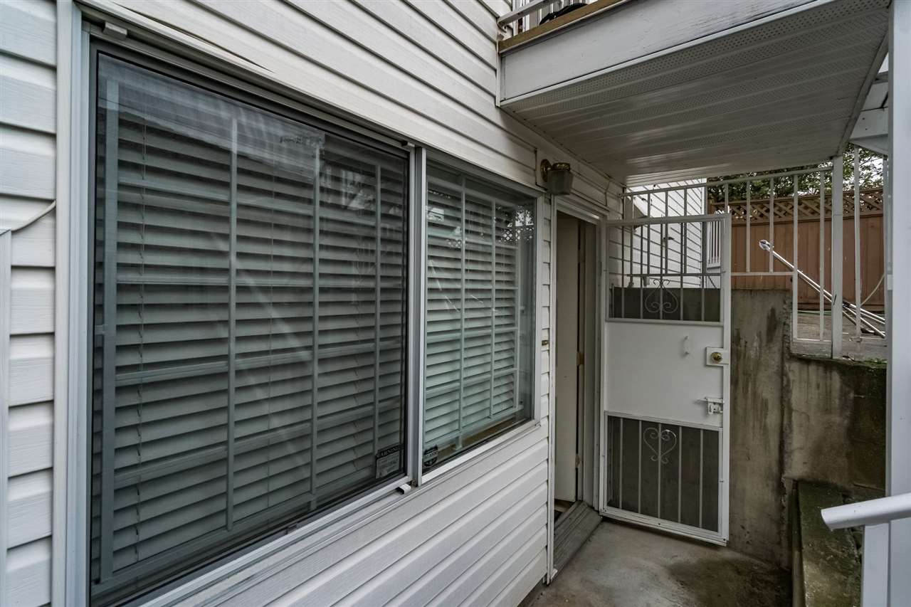The covered side walkway, the stair down to the lower entry along the house.
