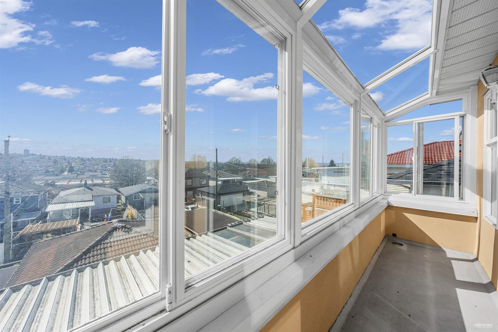 The solarium, a narrow glazed strip along the front of the house looking out over the rooftops.