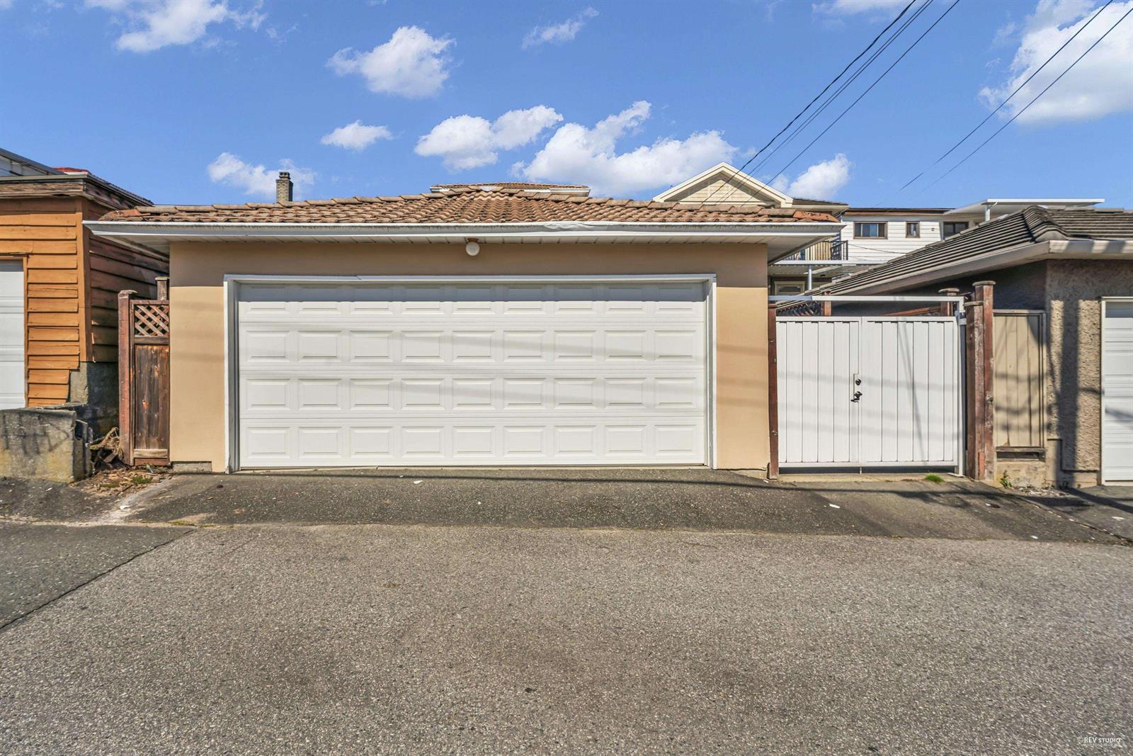 The double garage off the lane at the back, with room to park in front of it.