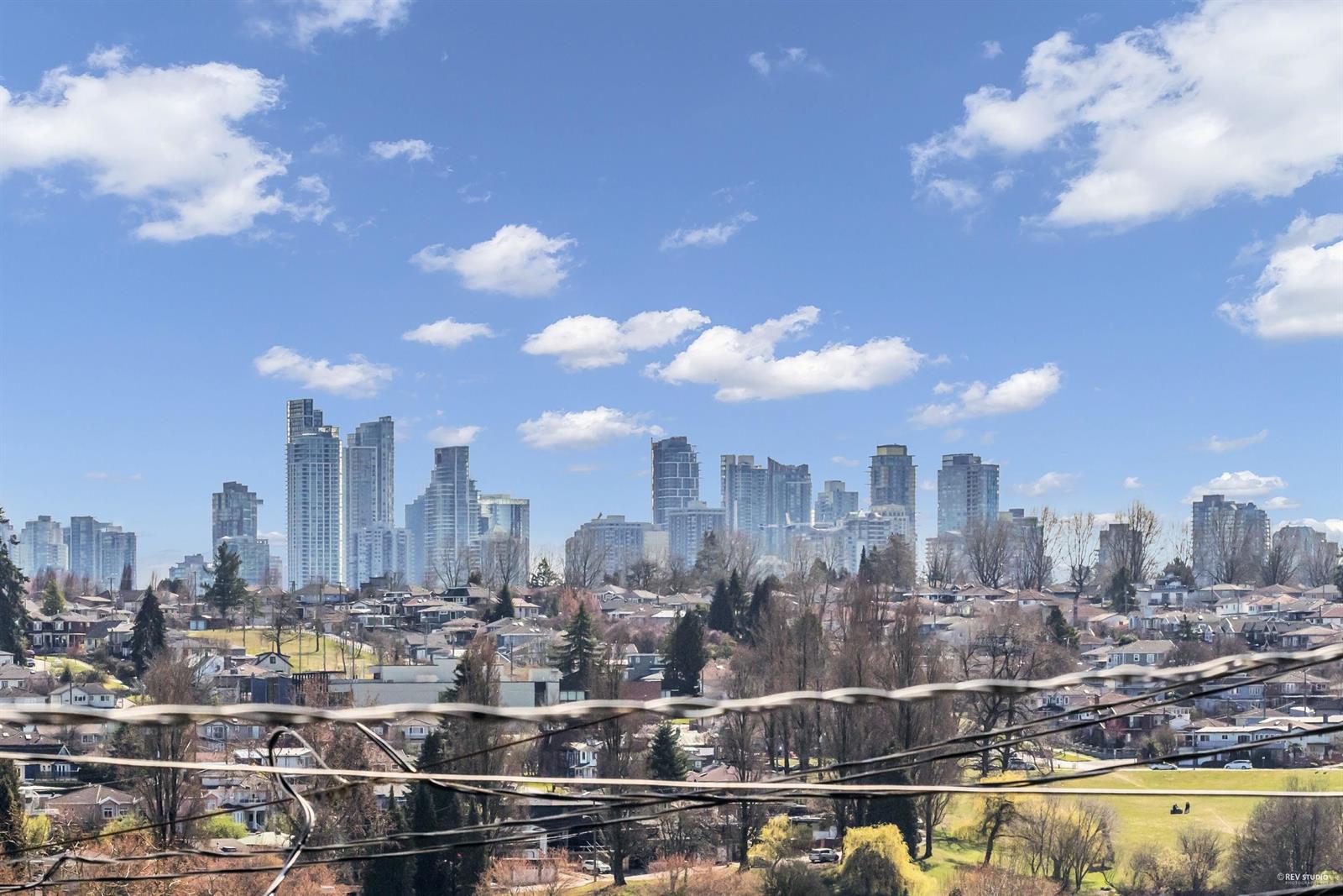 The view out over the neighbourhood rooftops to a skyline of towers on the horizon.