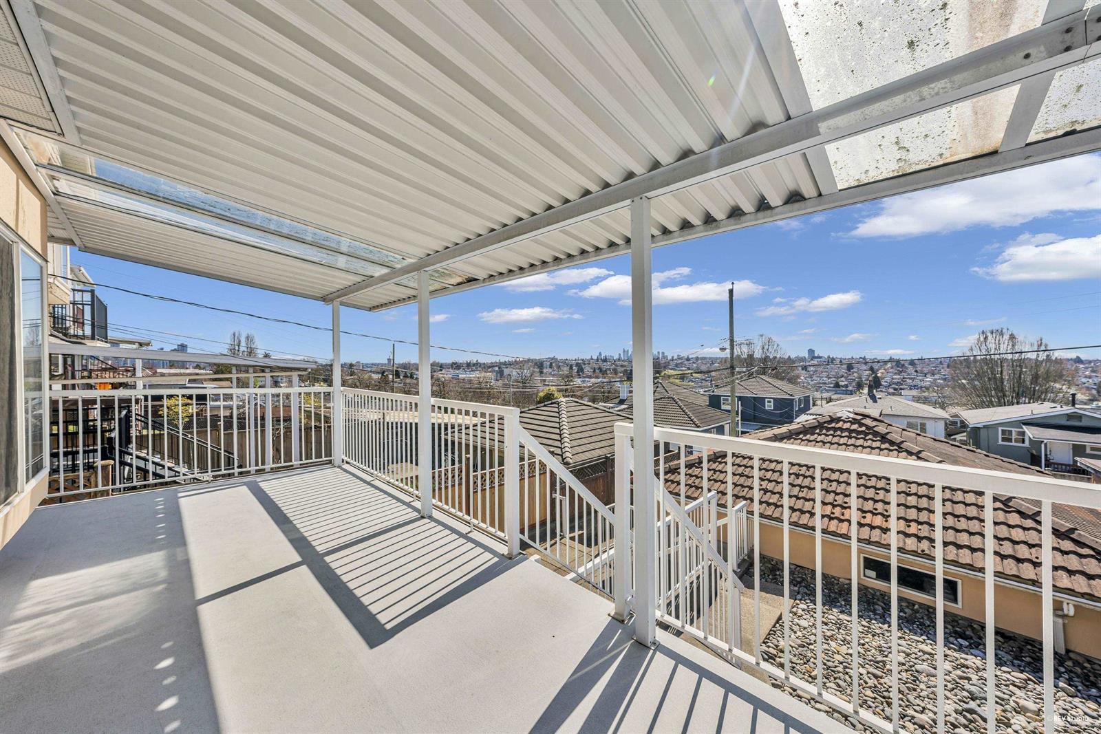 The covered sundeck off the main floor, running the width of the house above the rooftops.