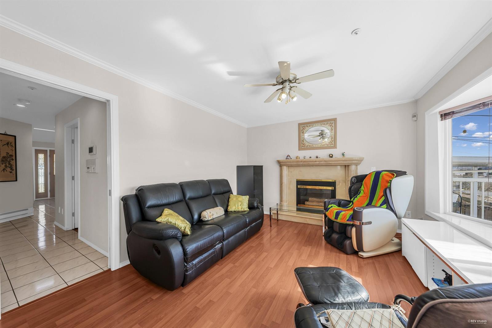 The upper family room, a gas fireplace between windows that look out over the view.