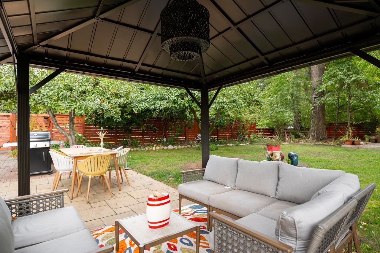 The gazebo up close, the table on one side and the outdoor sofa on the other.