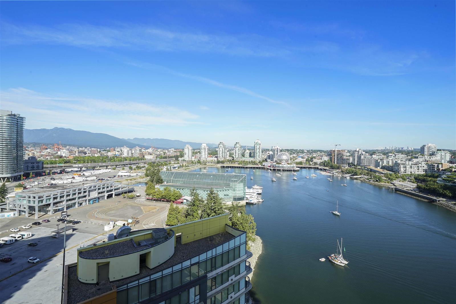 The view over False Creek, the marina below and the North Shore mountains along the far edge.