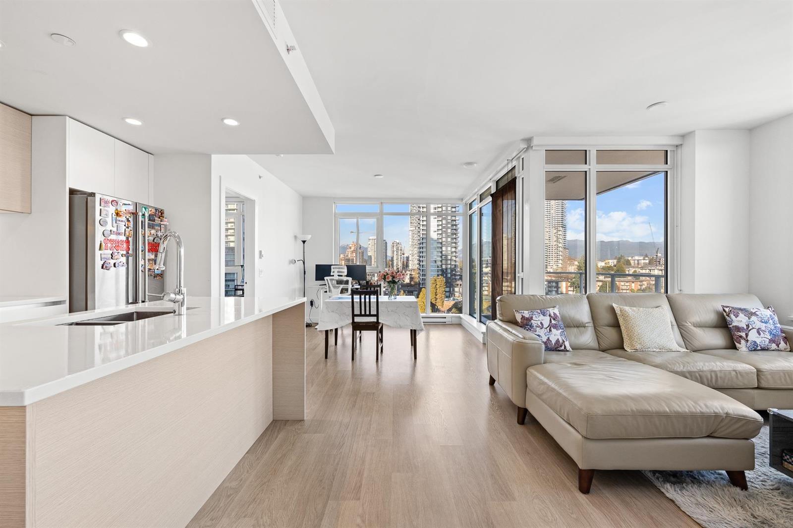 From the kitchen counter across the living room to the corner windows.