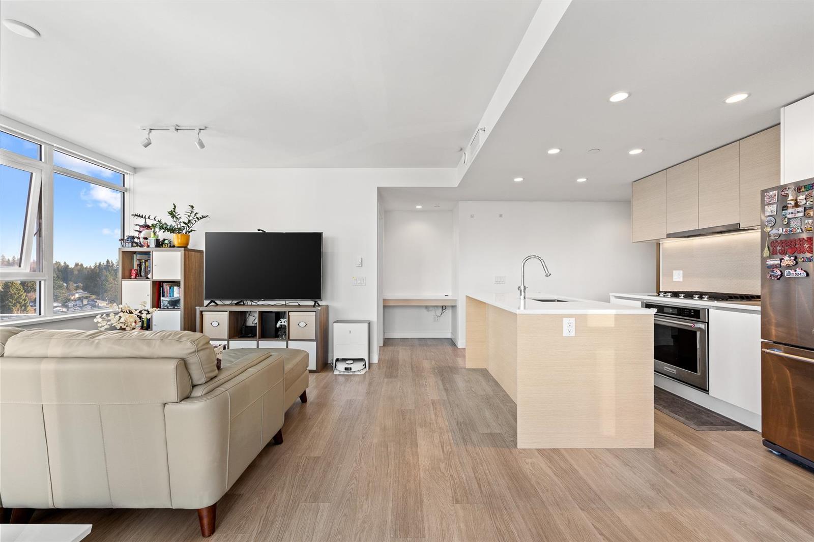 Over the sofa to the kitchen island and the hall.